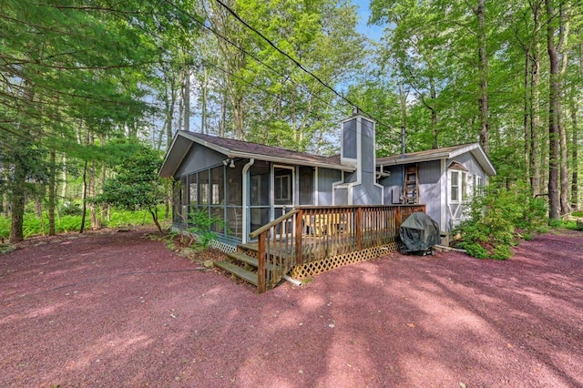 115 Alpine Ct, Pocono Pines, PA 18350 - rear view of house with a sunroom, a chimney, and a deck