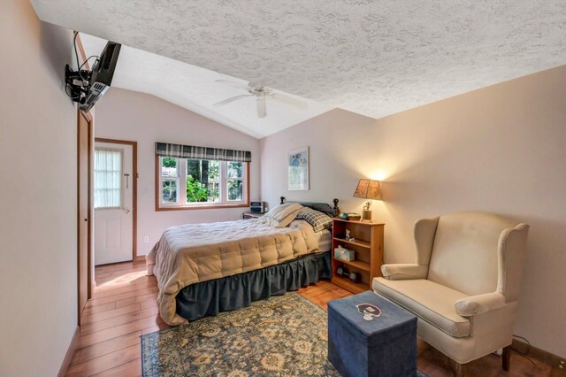 115 Alpine Ct, Pocono Pines, PA 18350 - bedroom featuring lofted ceiling, a textured ceiling, wood finished floors, and ceiling fan