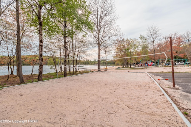 surrounding community featuring a water view and volleyball court