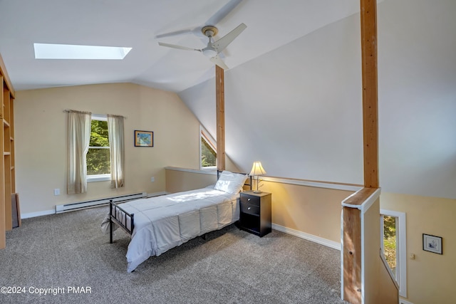 carpeted bedroom with baseboard heating, vaulted ceiling with skylight, baseboards, and ceiling fan