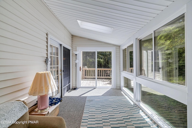 sunroom with a wealth of natural light and lofted ceiling with skylight