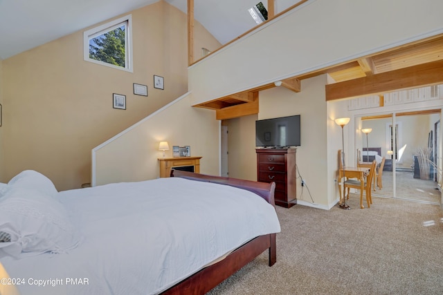 carpeted bedroom featuring high vaulted ceiling