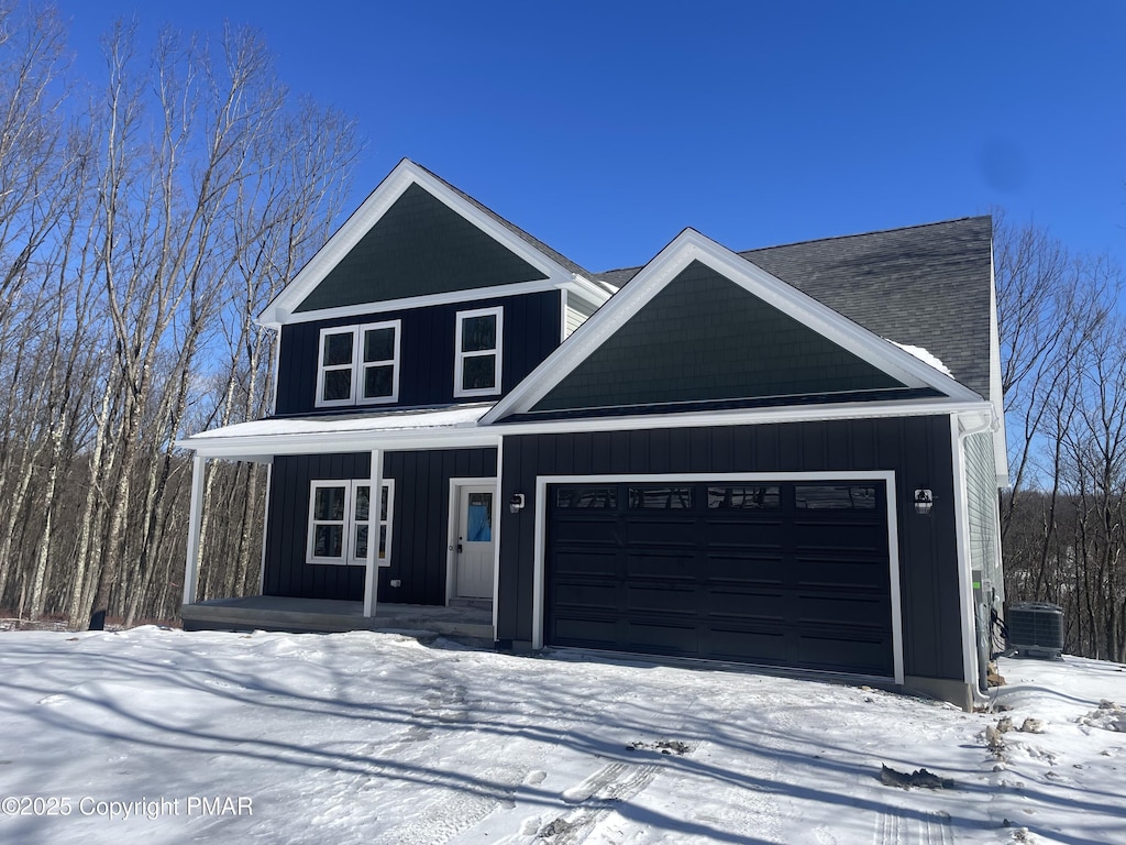 180 Stone Ridge Rd, Albrightsville, PA 18210 - view of front of home featuring a garage, covered porch, central air condition unit, and board and batten siding