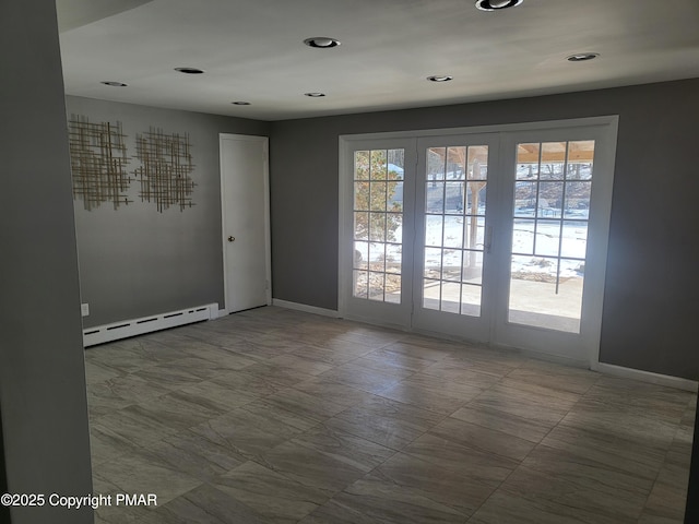 spare room with plenty of natural light, a baseboard heating unit, baseboards, and recessed lighting