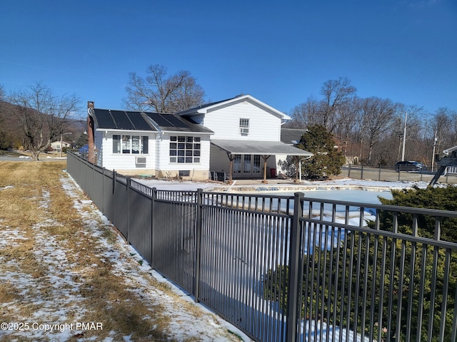 back of house with a fenced front yard