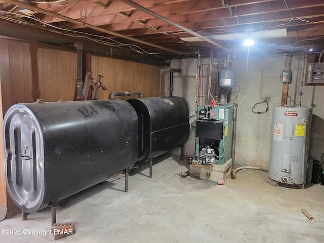 utility room with a heating unit, electric panel, electric water heater, and heating fuel