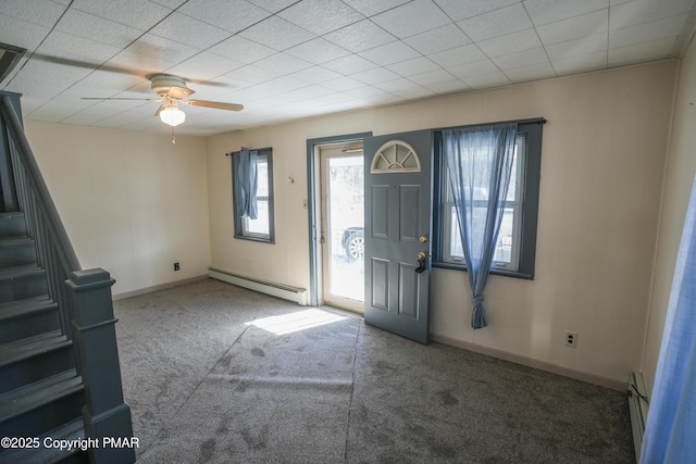 carpeted entryway featuring baseboard heating and ceiling fan