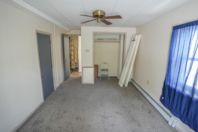 carpeted spare room with lofted ceiling and a baseboard radiator