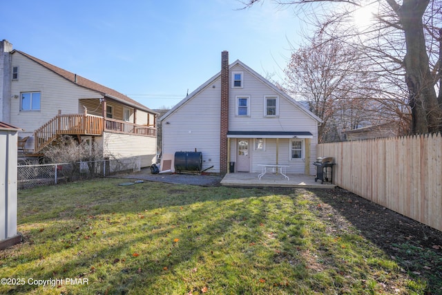 back of property with a patio and a yard