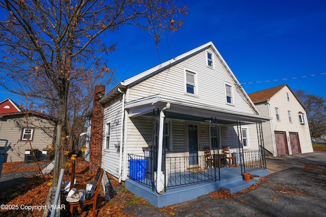 bungalow with a garage and covered porch