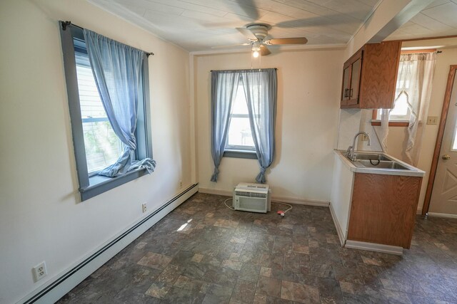 unfurnished room with baseboards, ceiling fan, a baseboard heating unit, and stone finish floor