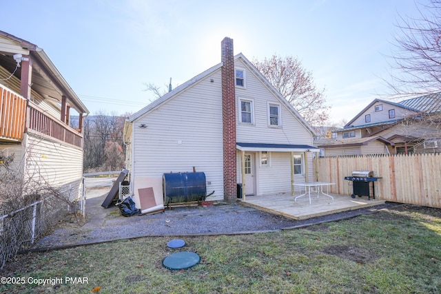 rear view of house with a yard and a patio area