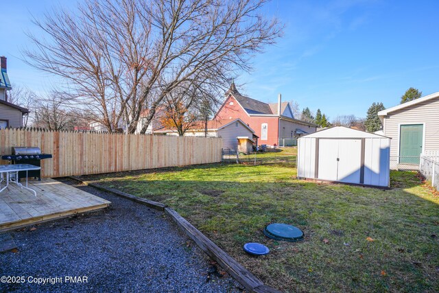 view of yard featuring a shed and a wooden deck