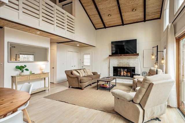 73 Big Bass Dr, Gouldsboro, PA 18424 - living area with high vaulted ceiling, wooden ceiling, wood finished floors, a brick fireplace, and beamed ceiling