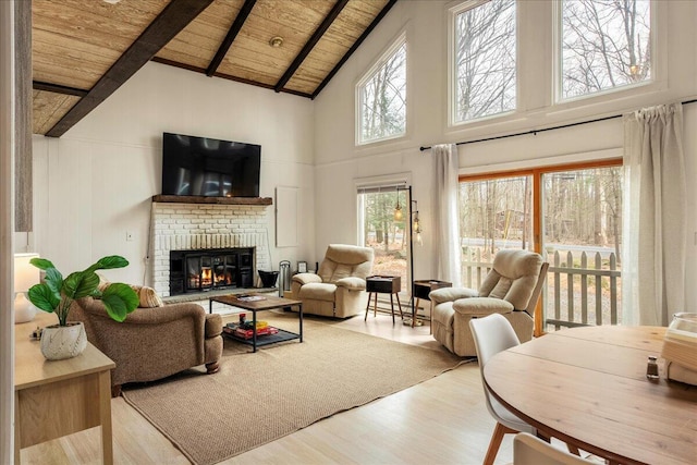 73 Big Bass Dr, Gouldsboro, PA 18424 - living room with high vaulted ceiling, wood ceiling, beam ceiling, a brick fireplace, and wood finished floors