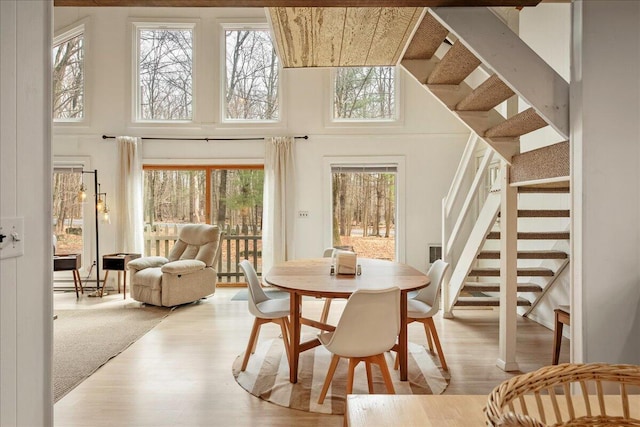 73 Big Bass Dr, Gouldsboro, PA 18424 - dining area with a high ceiling, stairs, a wealth of natural light, and wood finished floors