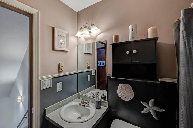 half bath featuring toilet and vanity