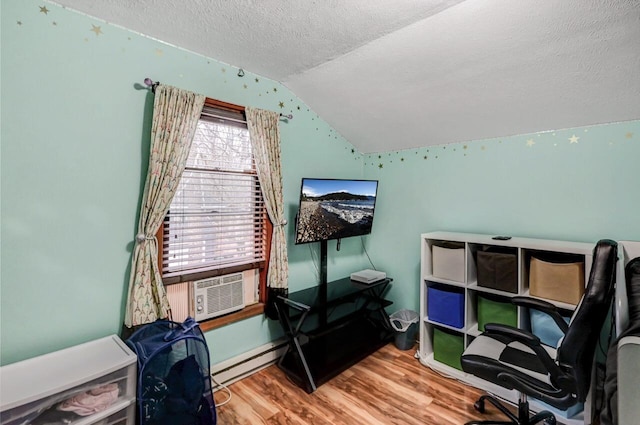 home office with cooling unit, vaulted ceiling, a textured ceiling, baseboard heating, and wood finished floors