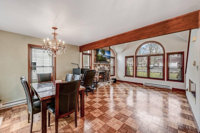 dining area featuring baseboards, an inviting chandelier, a stone fireplace, and a baseboard radiator