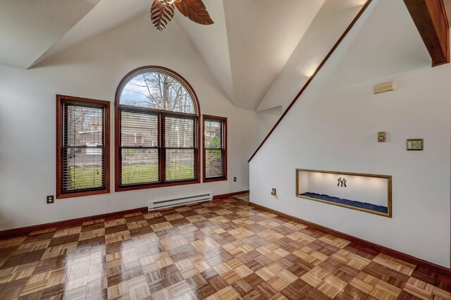 interior space featuring baseboard heating, baseboards, ceiling fan, and high vaulted ceiling