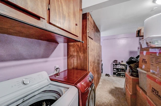 clothes washing area with cabinet space, carpet, and washing machine and clothes dryer