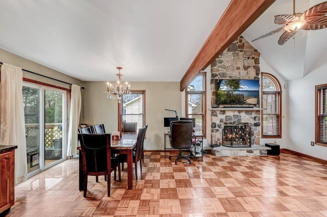 dining space with a fireplace, lofted ceiling with beams, ceiling fan with notable chandelier, and baseboards
