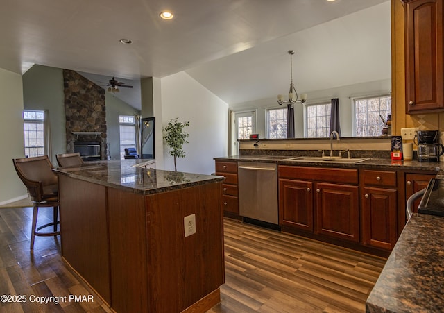 kitchen with dishwasher, dark wood-type flooring, vaulted ceiling, and a sink