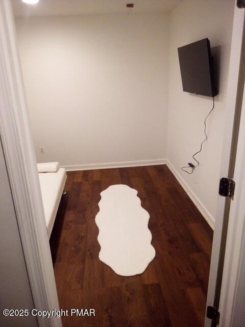 bathroom with wood finished floors and baseboards