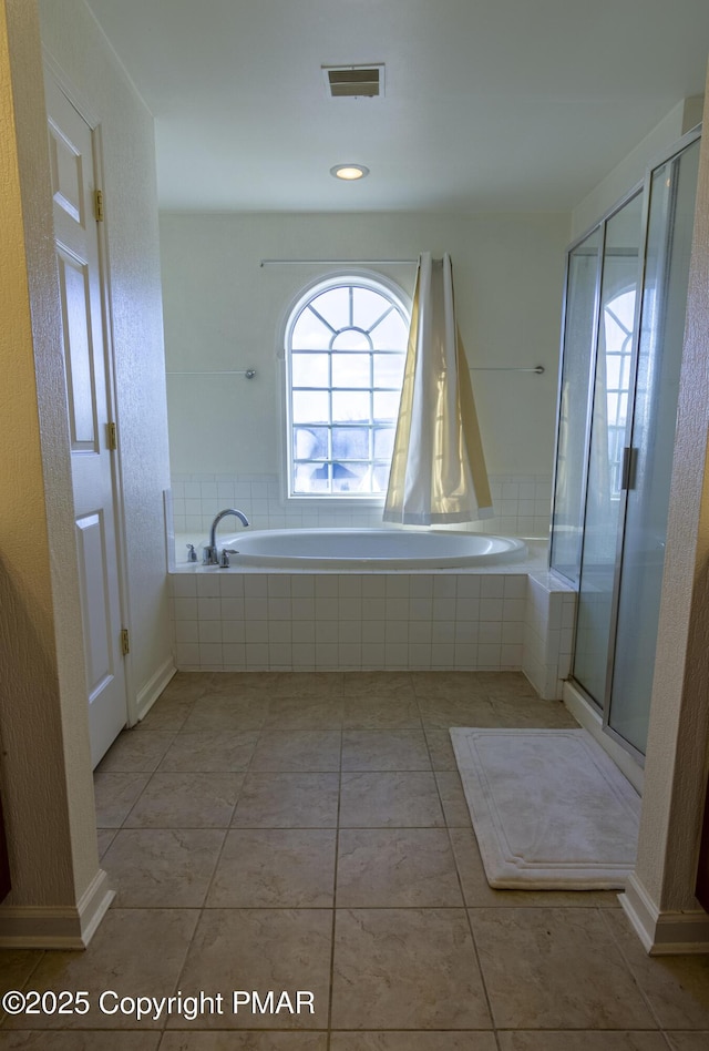 bathroom with tile patterned floors, a garden tub, and a shower stall