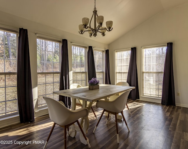 dining space featuring lofted ceiling, a healthy amount of sunlight, dark wood-style flooring, and a notable chandelier