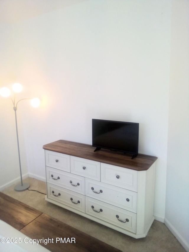 room details featuring baseboards and wood finished floors