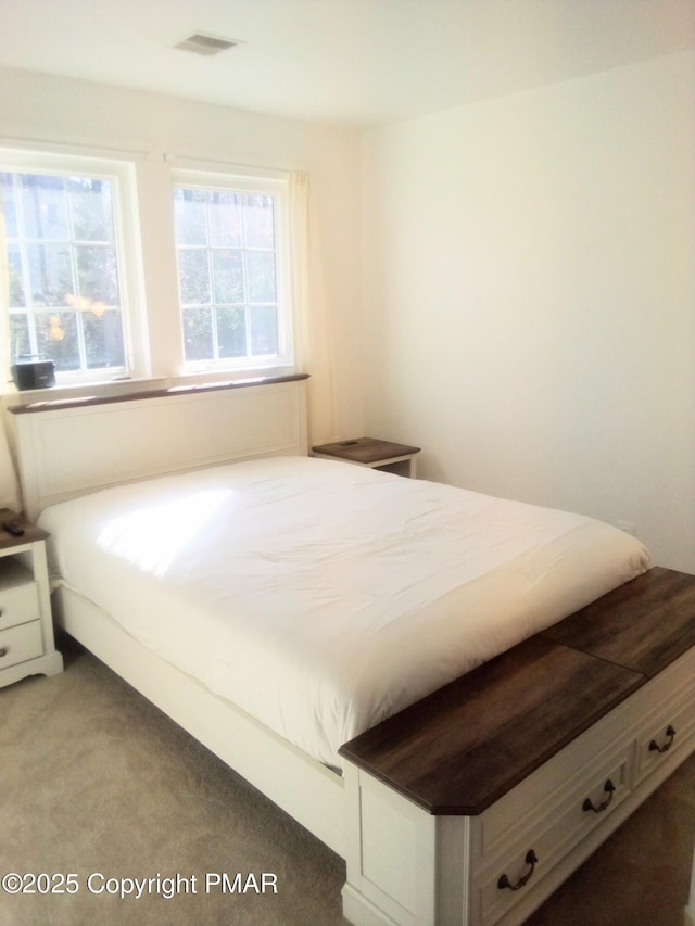 bedroom with carpet flooring and visible vents