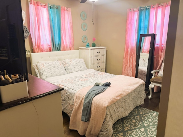 bedroom with a ceiling fan and wood finished floors