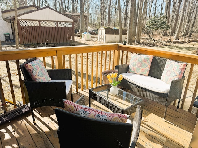 wooden deck with an outbuilding, an outdoor living space, and a storage unit