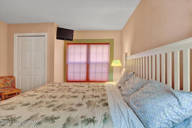 bedroom with a closet and a textured ceiling