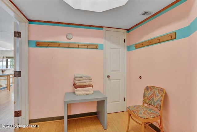 interior space with visible vents and wood finished floors