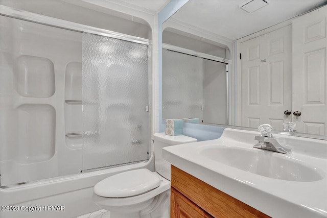 bathroom featuring combined bath / shower with glass door, vanity, and toilet