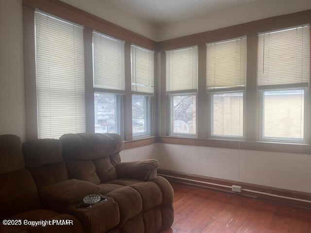 living area with a healthy amount of sunlight and wood finished floors