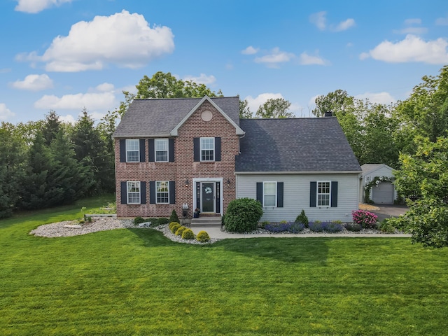 386 Daniel St, Allentown, PA 18104 - colonial home with a front lawn, a shingled roof, an outbuilding, brick siding, and a detached garage