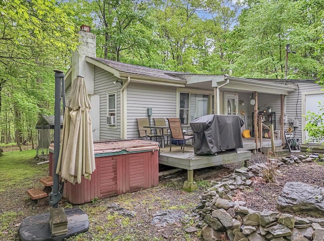 3405 Masons Ln, East Stroudsburg, PA 18302 - rear view of property featuring a hot tub, a wooden deck, and a chimney