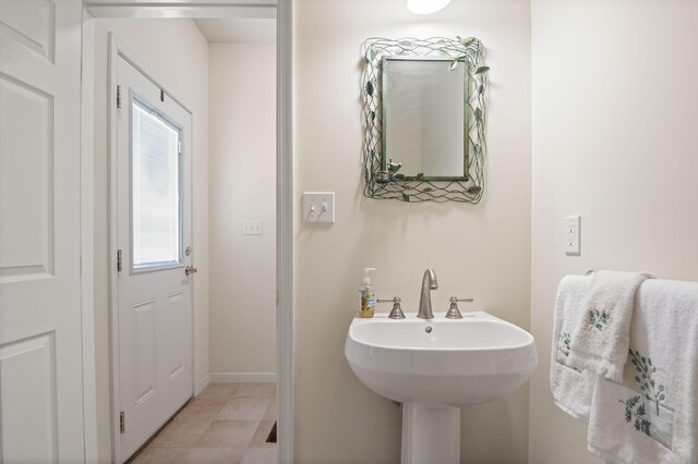 bathroom with baseboards and a sink