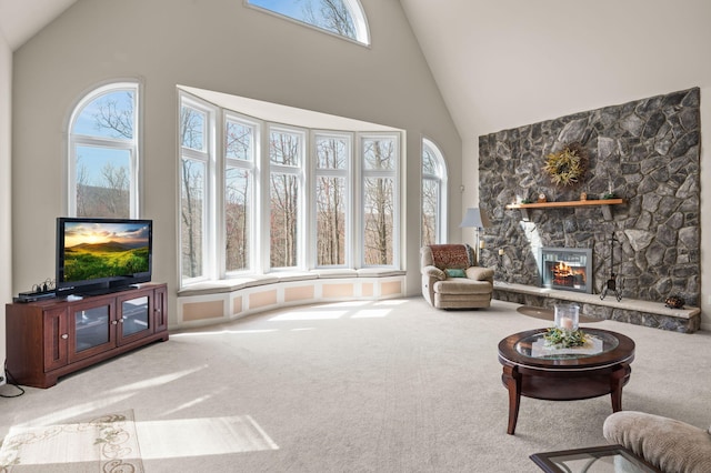 living area with high vaulted ceiling, carpet, and a wealth of natural light