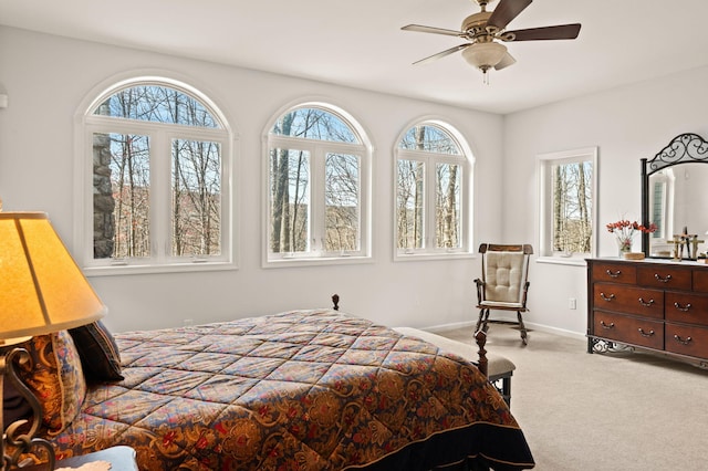 bedroom featuring baseboards, a ceiling fan, and carpet