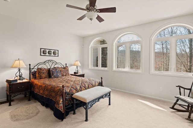carpeted bedroom featuring a ceiling fan and baseboards