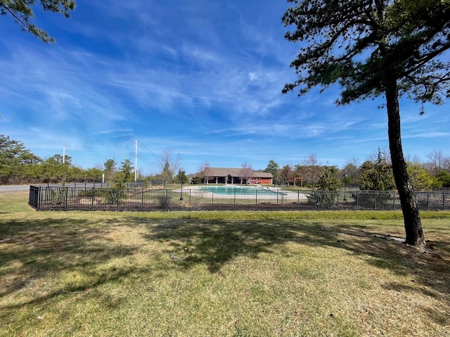view of yard with fence and a fenced in pool
