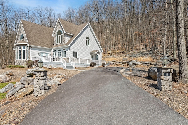 view of front facade featuring roof with shingles