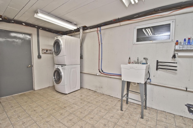clothes washing area featuring estacked washer and dryer