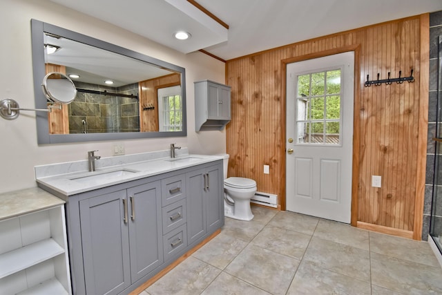 full bath featuring a baseboard radiator, a shower stall, toilet, double vanity, and wooden walls