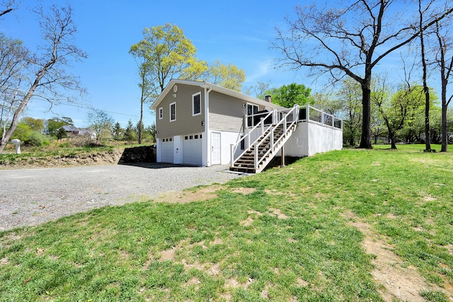 23 Primrose Dr, East Stroudsburg, PA 18302 - view of front of house featuring a chimney, a front yard, gravel driveway, an attached garage, and stairs