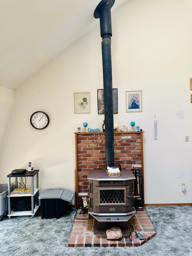 detailed view of a wood stove, carpet floors, and baseboards